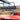 A black leather bench seat sits next to the square red metal fender of a forecart. Attaching the seat to the fender is a leaf spring suspension made with black steel. A leaf spring suspension reduces bouncing for a smoother drive.