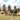 ACS Forcart in a field with Tongue installed and a Draft horses hooked up and a woman and boy in the cart pulling a hay trailer
